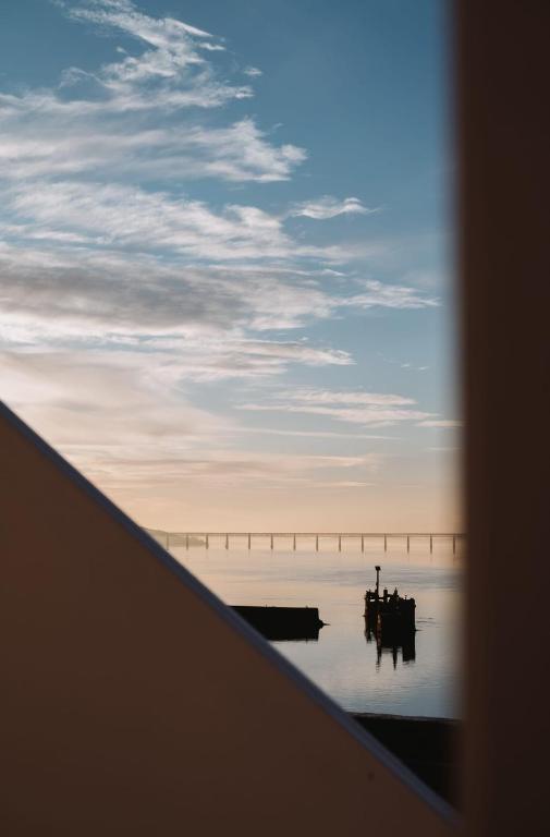 a view of a bridge over the water at sunset at The Newport Inn in Newport-On-Tay