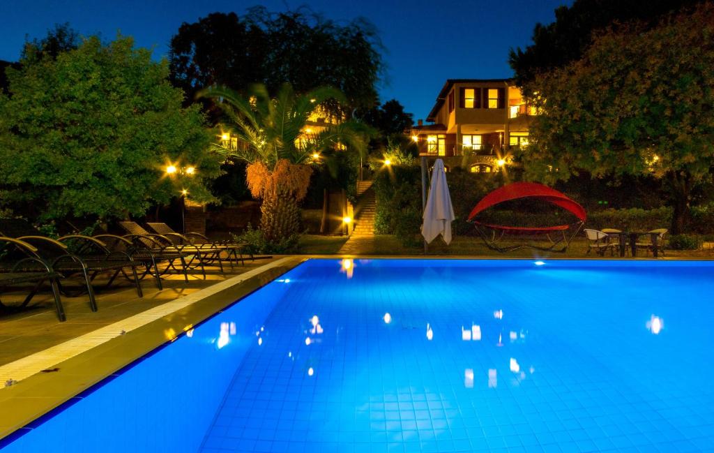 a swimming pool in front of a house at night at Marmaris Holiday Villas in Marmaris
