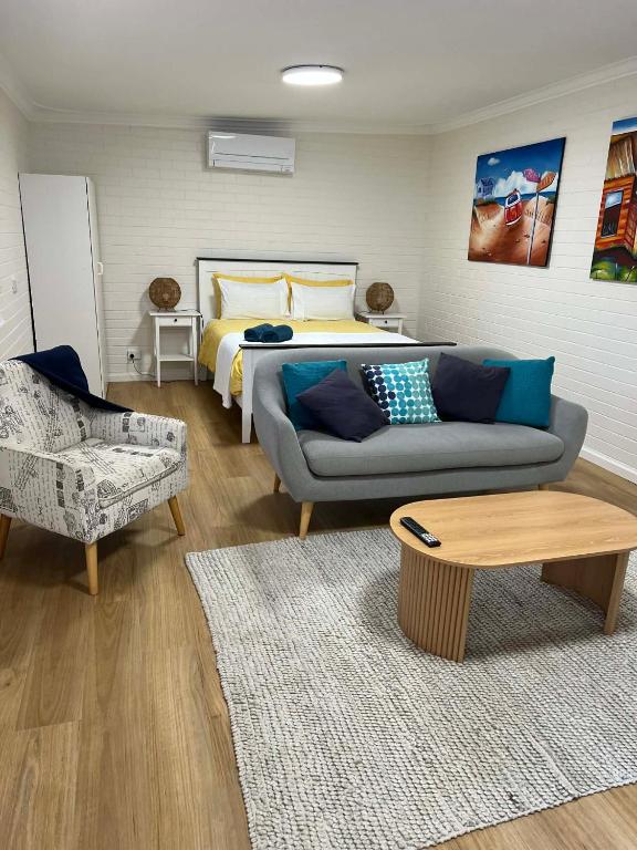 a living room with a couch and a bed at Beach House Studio in Busselton