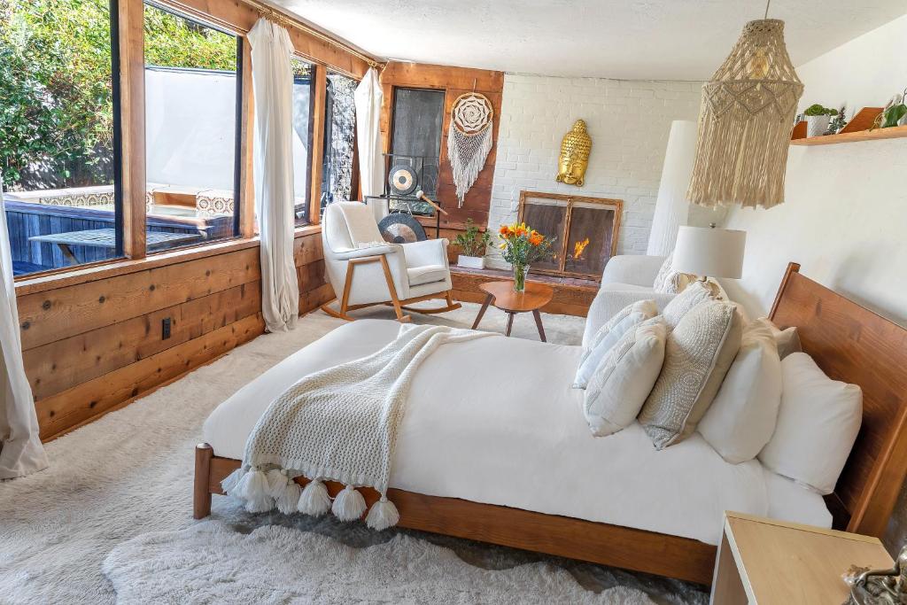 a bedroom with a large bed and a fireplace at Enchanted Waterfall Sanctuary in Mill Valley