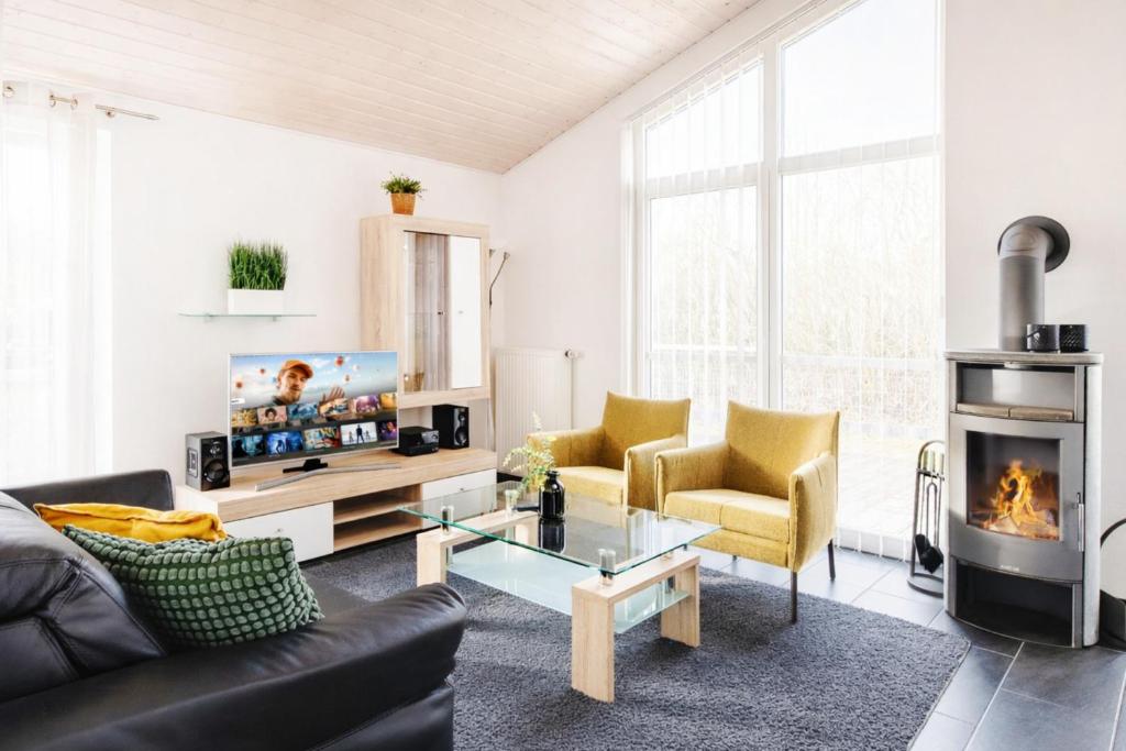 a living room with a couch and a fireplace at Haus Stressfrei - Nordhorn in Nordhorn