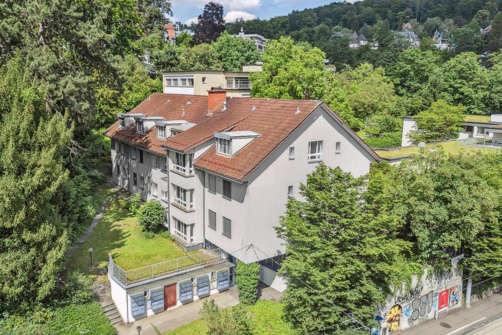 an aerial view of a white house with a red roof at Sigma Self Check-in Hostel in Zurich