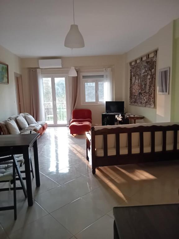 a living room with a couch and a table at Eva's apartments in Nafpaktos
