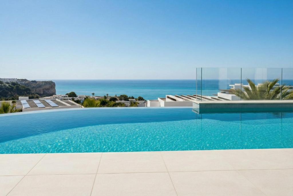 a swimming pool with a view of the ocean at Lirios 182 Cumbre del Sol in Benitachell