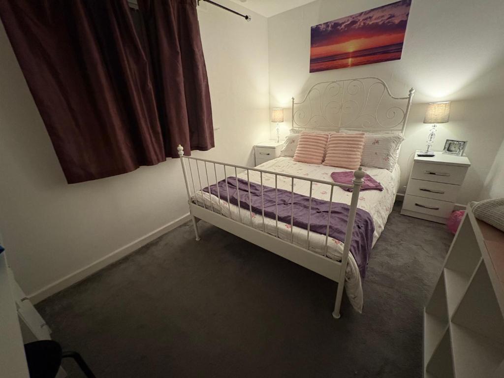 a small bedroom with a white bed and a window at Abbey Meadows View ABB in Redditch