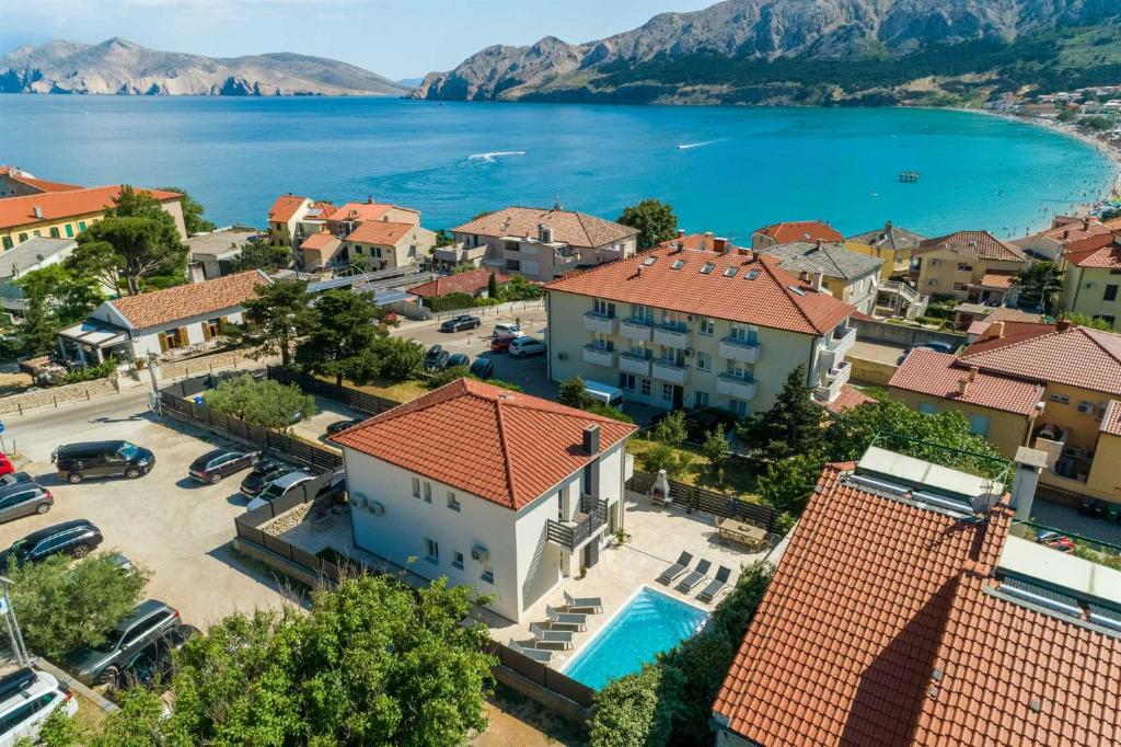 an aerial view of a house with a swimming pool at Villa BAŠKA near the beach in Baška