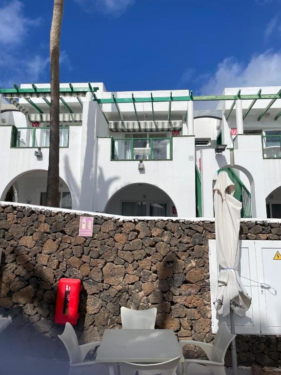 a toilet in front of a stone wall with a building at Casa Clara - Playa Matagorda in Puerto del Carmen