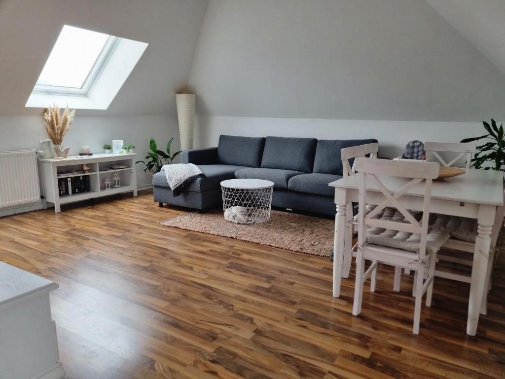 a living room with a blue couch and a table at Wohlfühlende Wohnung nähe Dortmund in Witten