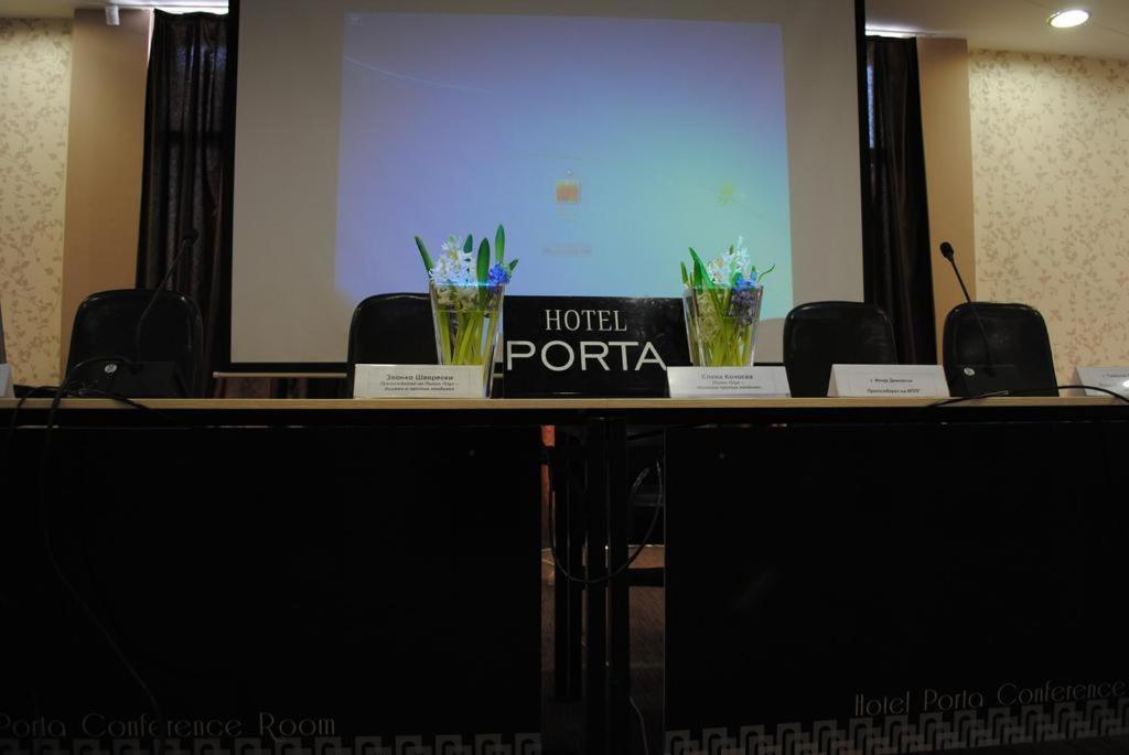 a conference room with a table with a hotel portal sign on it at Hotel Porta 26 in Skopje