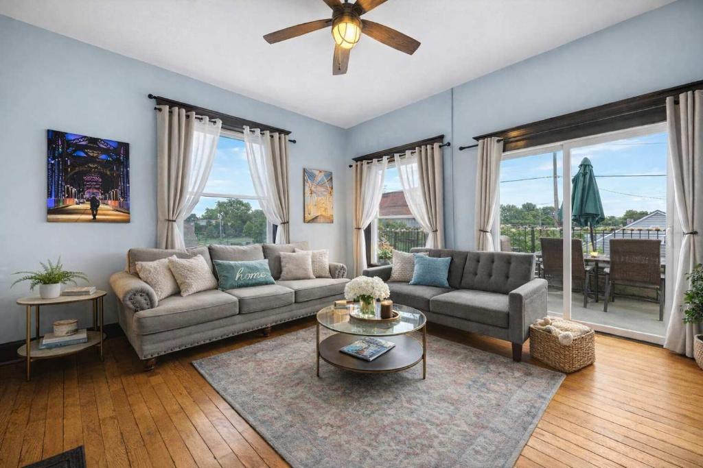 a living room with a couch and a table at Walkable Historic District Riverview Escape in Jeffersonville