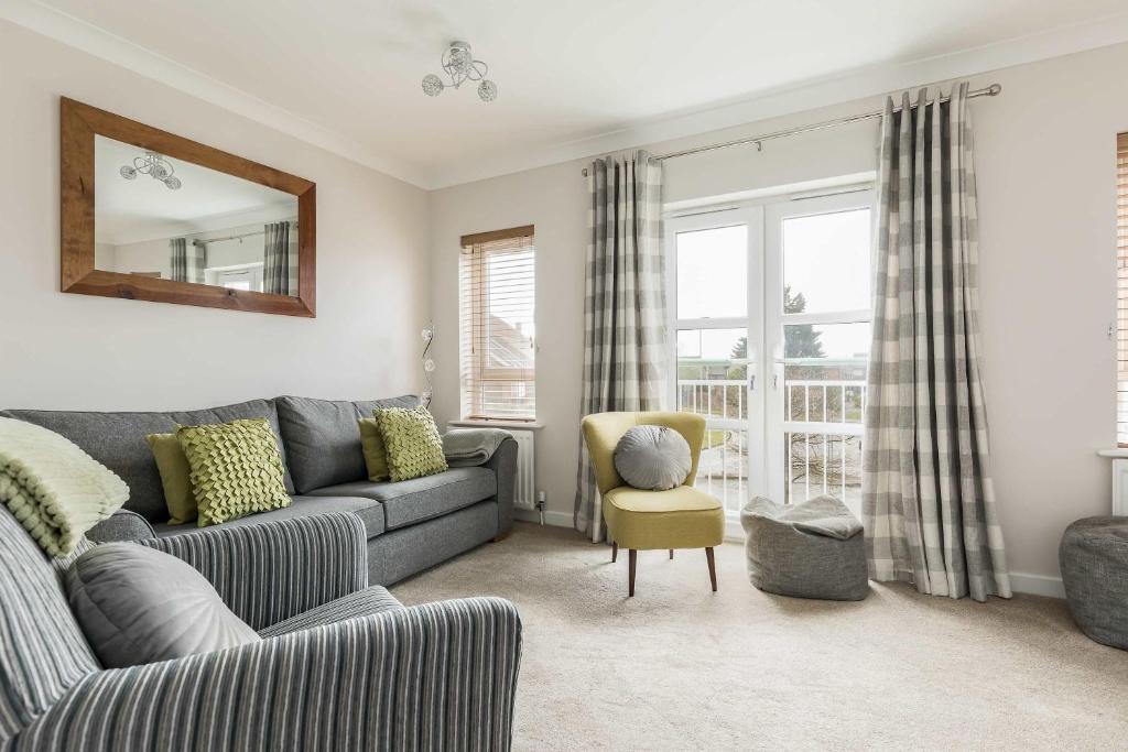 a living room with a couch and a chair at Avalon - Walking Distance to Poole Quay and Town in Poole