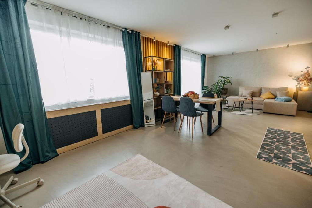 a living room with a table and a couch at Studio49apartments Quiet in Niš Free Private Parking Fast WiFi in Niš