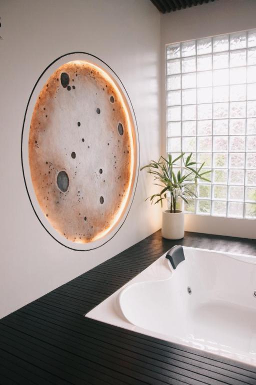 a bathroom with a sink and a mirror on the wall at Liorasuite 4 Bedroom Jacuzzi Billiard Pingpong in KBP in Padalarang