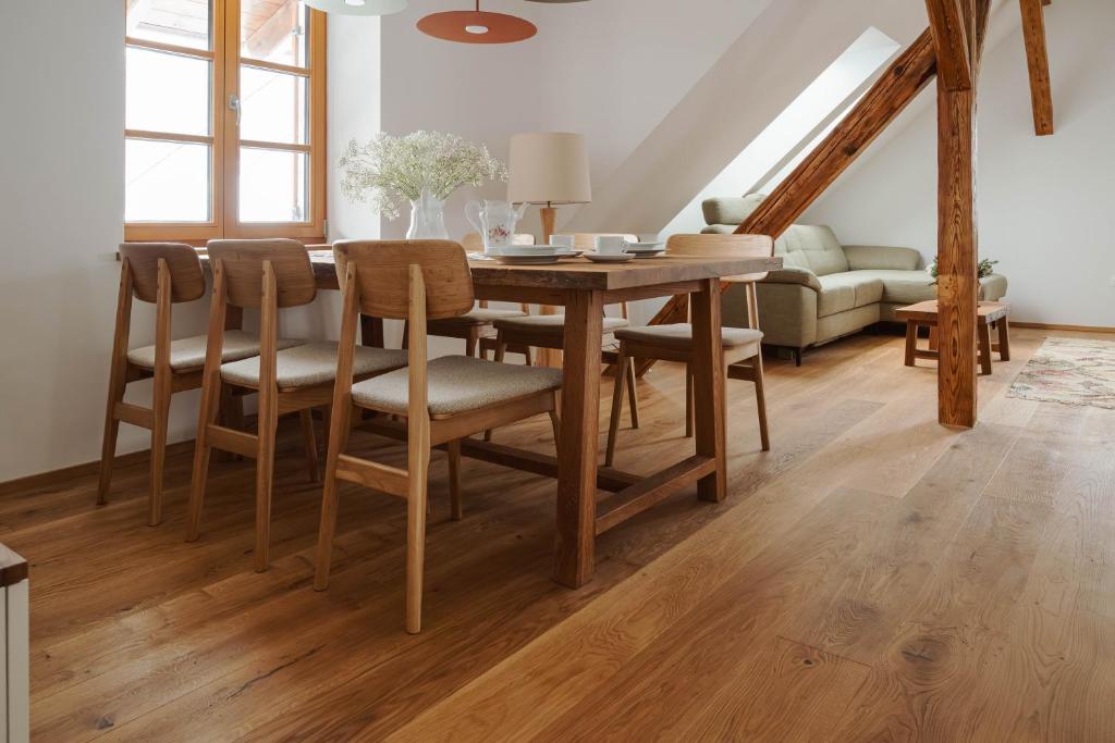 a dining room with a wooden table and chairs at Apartmaji Matec in Fala