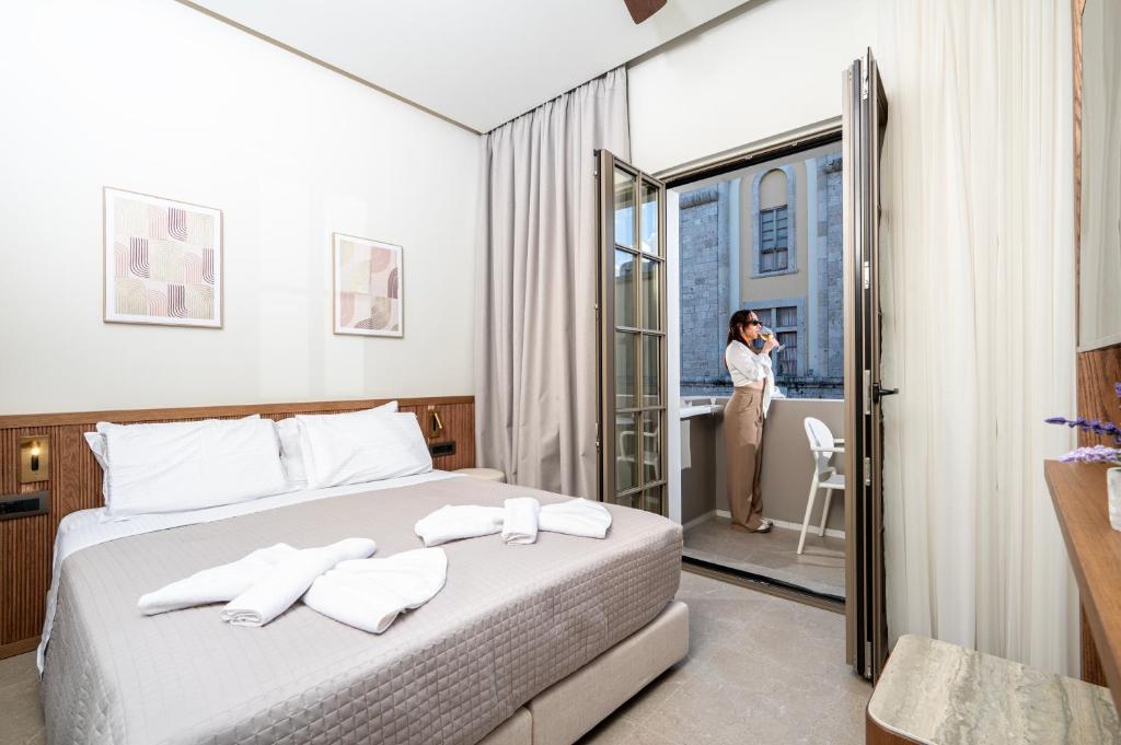 a woman taking a picture of a hotel room at Volaka Luxury Suites in Kos