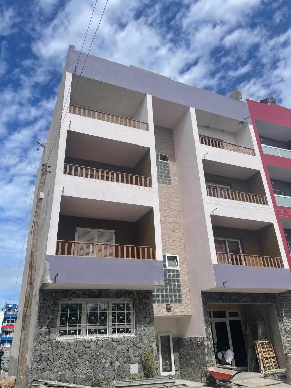 a white building with balconies on the side of it at SOL AZUL in Santa Maria