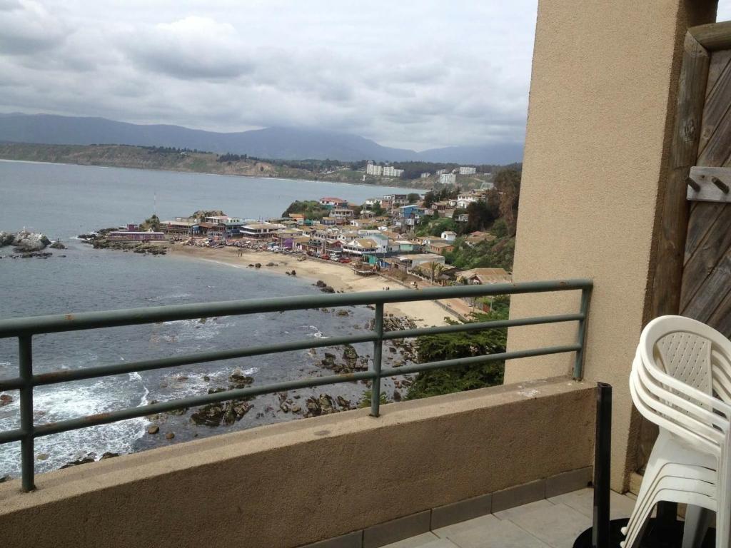 a balcony with a view of a beach at Horcon Condominio CAUCAU in Horcón