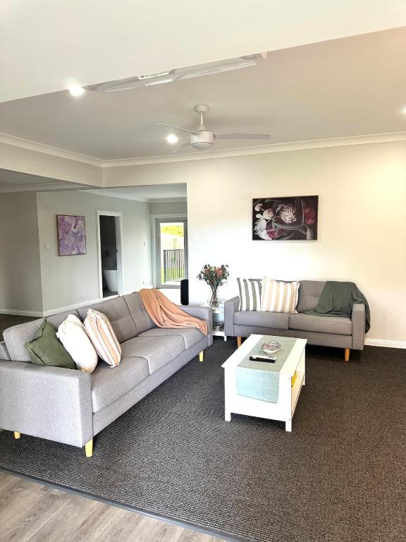 a living room with two couches and a coffee table at Escape on Eighth Poolside Comfort Close to CBD in Mildura