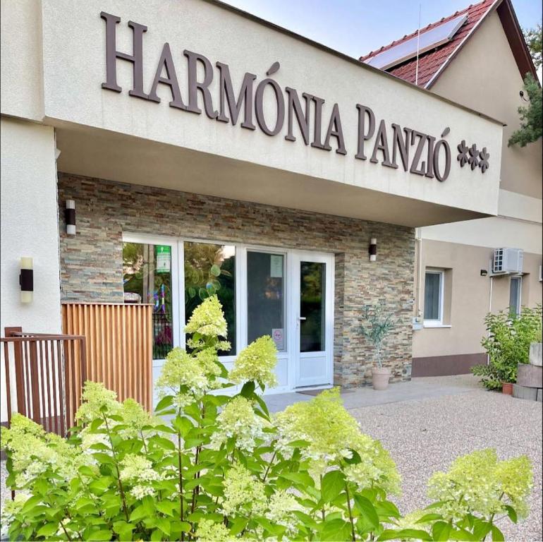 a sign on the front of a hamona pampota building at Harmónia Panzió in Bogács