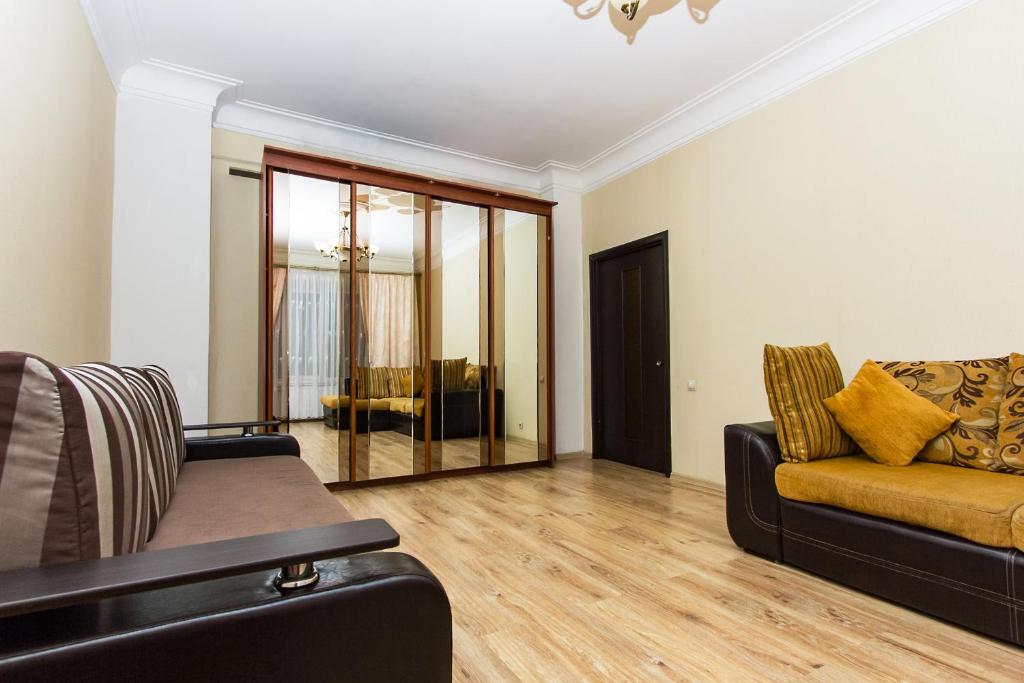 a living room with a couch and a chair at ApartLux Serpukhovskaya in Moscow