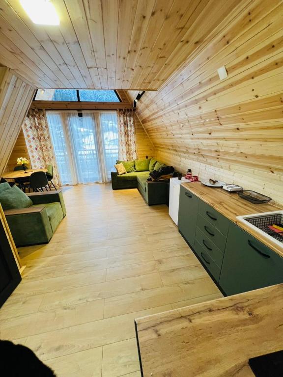 a large living room with wooden walls and wooden floors at Cottage Dachi in Mestia in Mestia