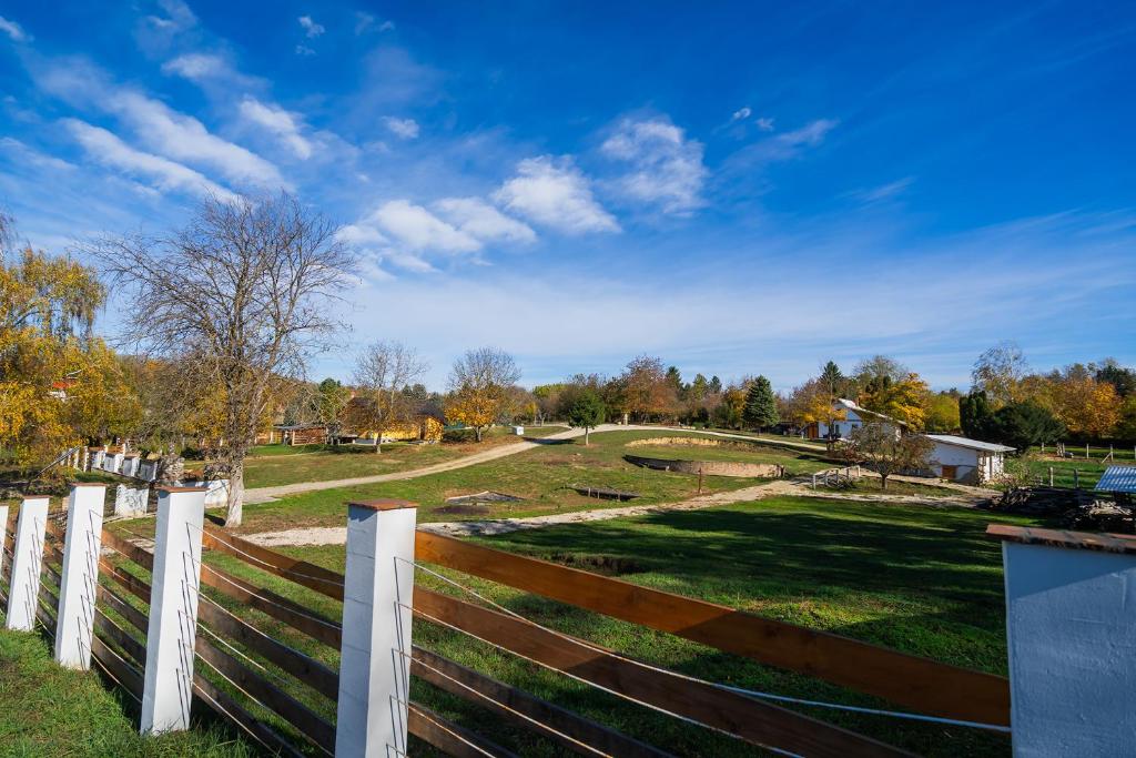 a fence in front of a yard with a field at Non stop apartman 3 in Kaposvár