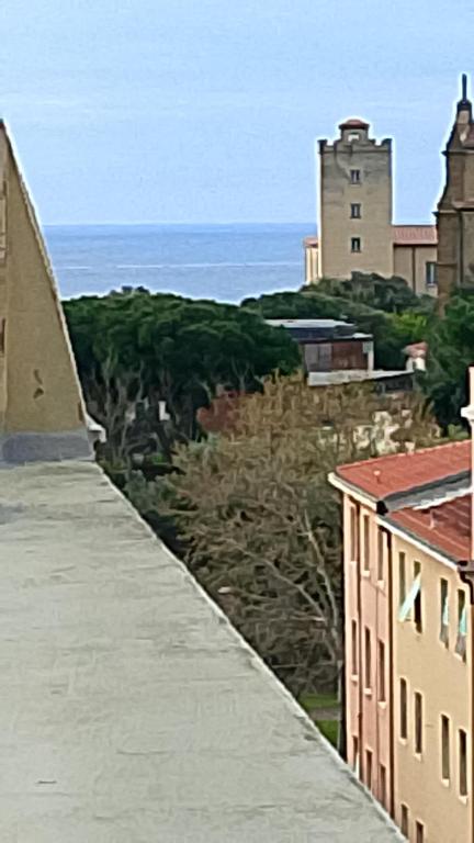 a view of the ocean from a wall with buildings at TCEM camera in attico 6 no ascensore in Piombino