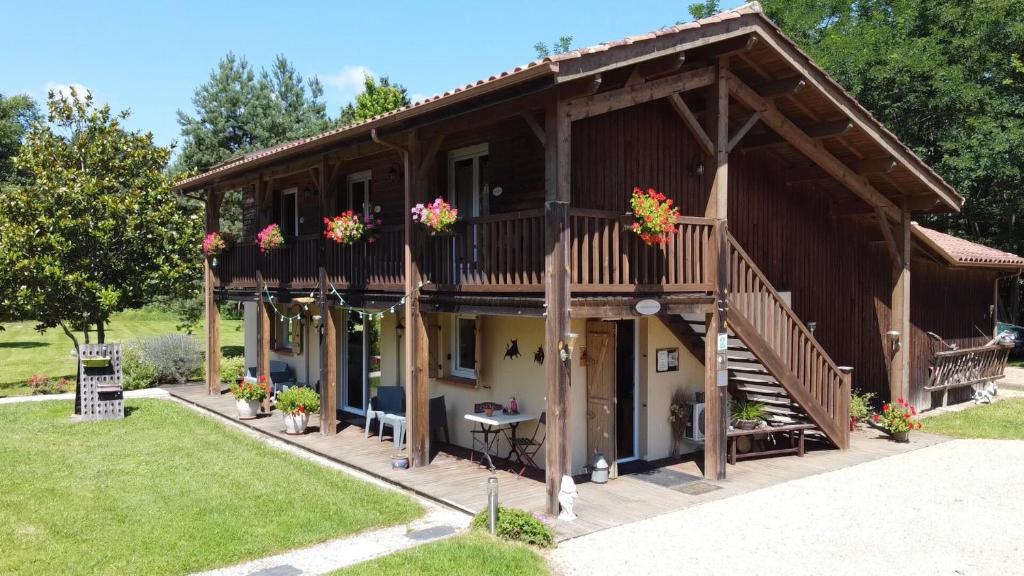 a house with flowers on the balconies of it at L'étable des amis in Escalans