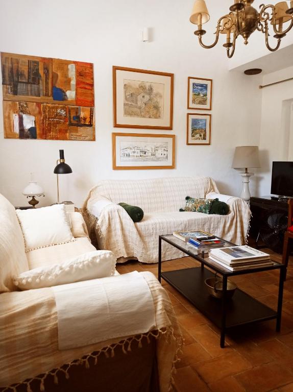a living room with two couches and a coffee table at Monte das Andorinhas Alentejo in Montemor-o-Novo