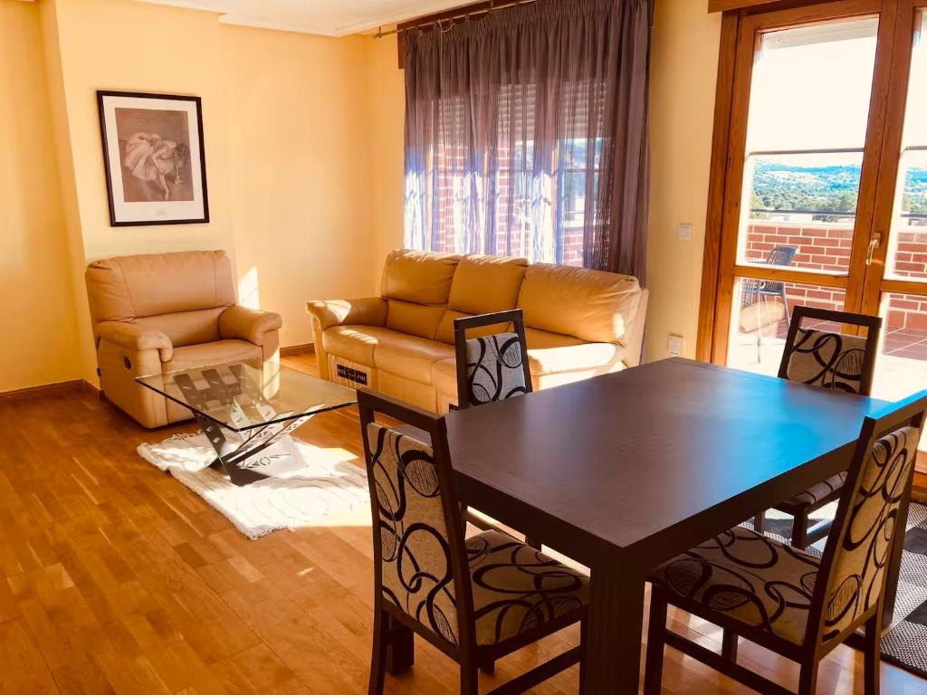 a living room with a table and a couch at Fuenteberros 1 in Golmayo
