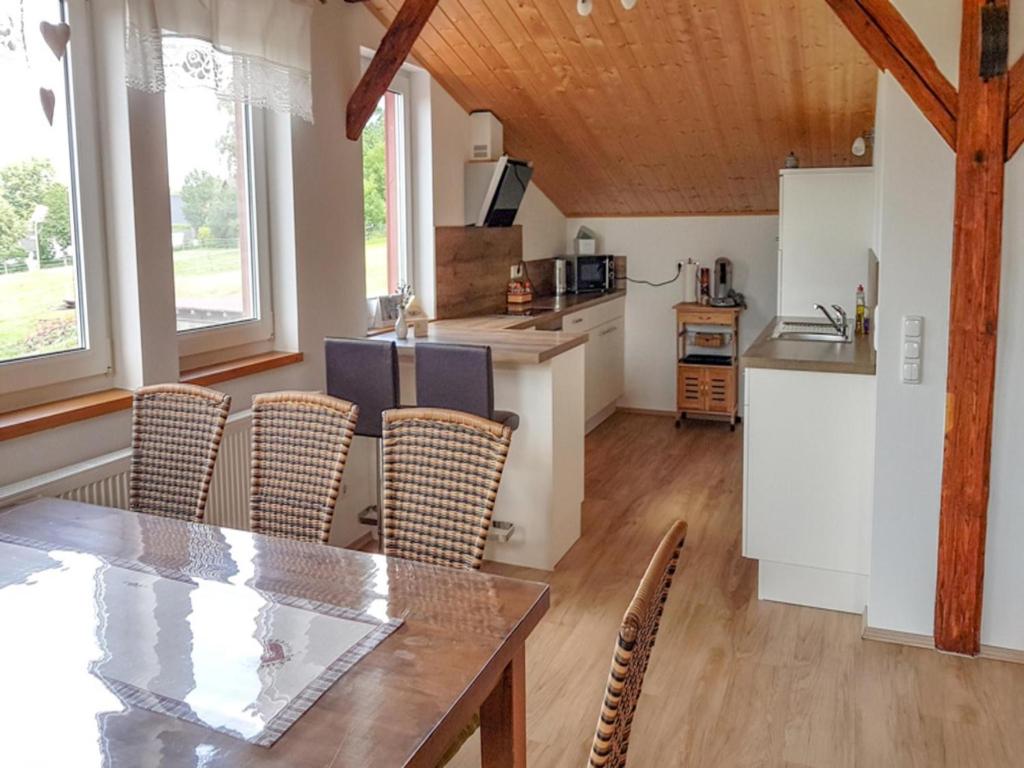 a kitchen and dining room with a table and chairs at Ferienwohnung Ruf in Küps