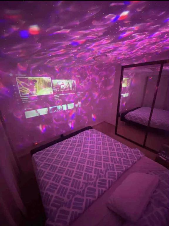 a bedroom with a purple ceiling and a bed at Hidden Gem North Sydney in Sydney