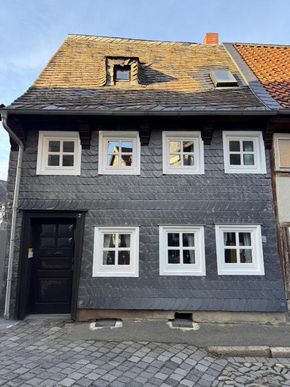 a black house with a black roof and white windows at Ferienhaus Winkelwerk in Goslar