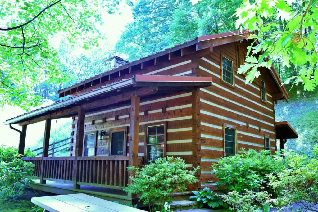 a log cabin in the woods with trees at The Cove in Canton