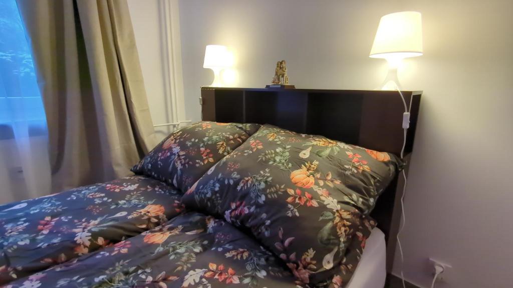 a bed with two pillows on it next to a window at Apartament Pola in Piła
