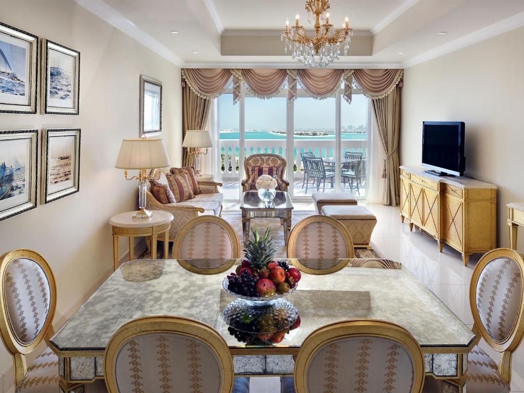 a living room with a table with fruit on it at Kempinski Hotel Palm Jumeirah in Dubai