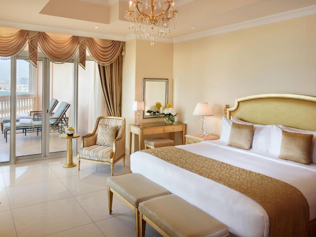 a hotel room with a large bed and a balcony at Kempinski Hotel Palm Jumeirah in Dubai