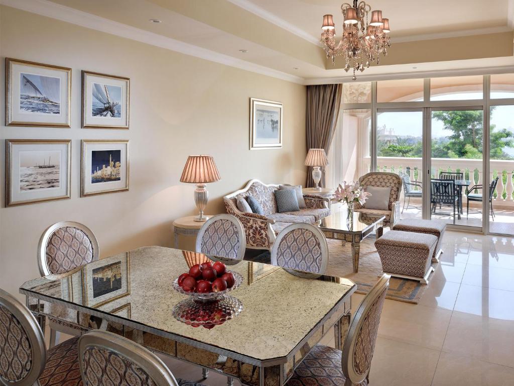 a living room with a table and chairs at Kempinski Hotel Palm Jumeirah in Dubai