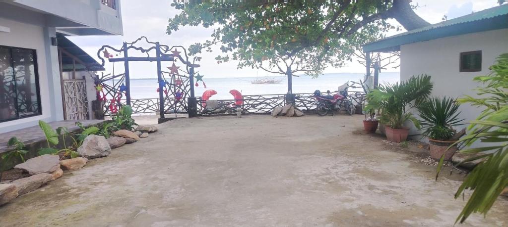 a porch of a house with a view of the ocean at La Bottega Pension House in Roxas