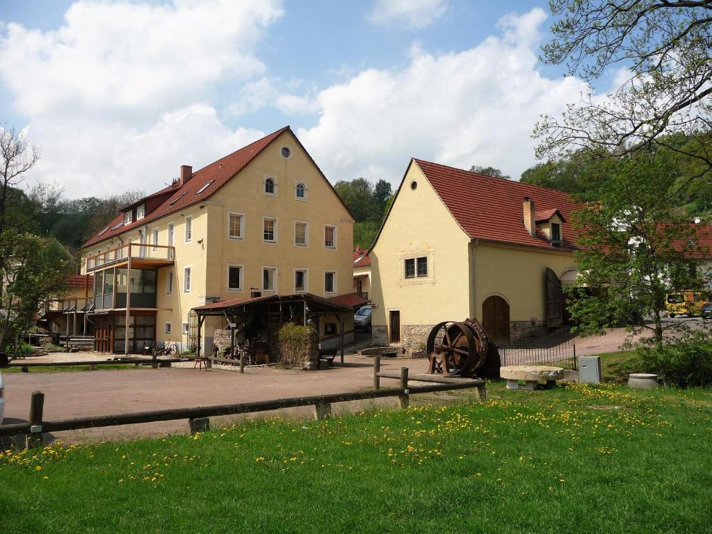 a group of buildings in a town with a yard at Barthmühle in Klipphausen