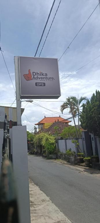 a sign on the side of a street at Dhika Adventure DPS in Denpasar