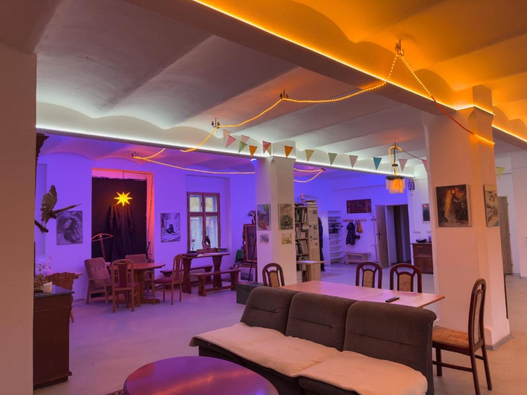 a living room with purple lighting and a couch at Krušnohorský Poutník in Kovářská