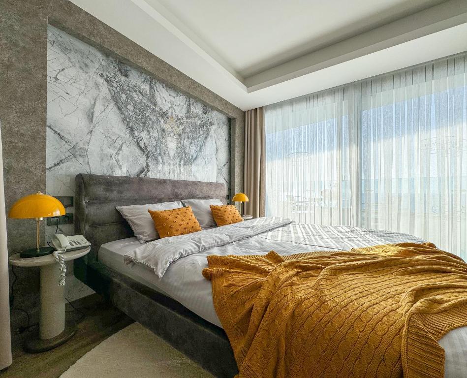 a bedroom with a bed and a large window at Qoople Elite Admiral Apartment in Alanya