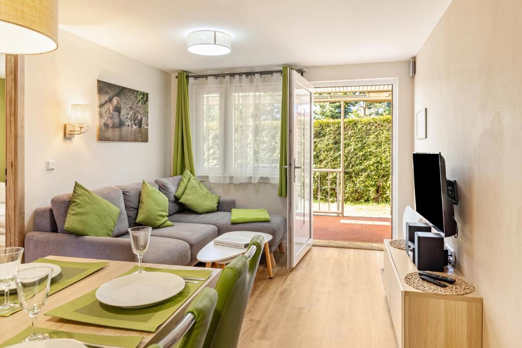 a living room with a couch and a table at Ferienhaus Biber im Sternenpark in Lochow