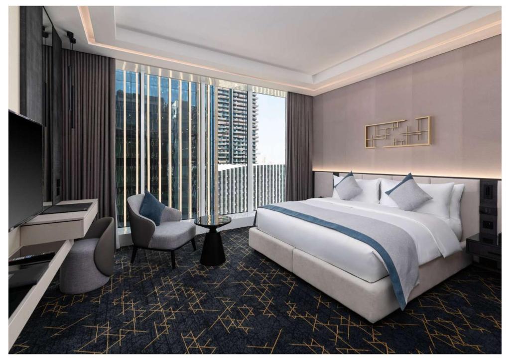 a bedroom with a large bed and a large window at Vittori Garden in Riyadh