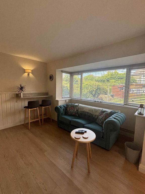 a living room with a green couch and a table at Apartment No 4 in Bridlington