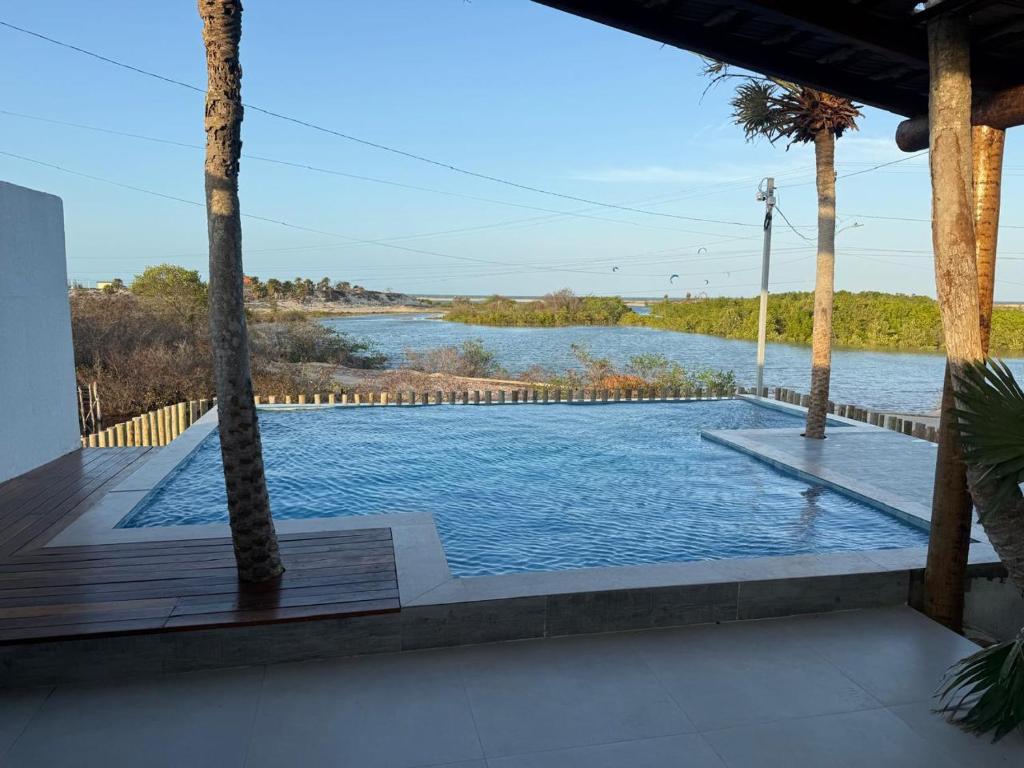 a swimming pool with a view of a river at Chalé Anjos Mar in Barrinha
