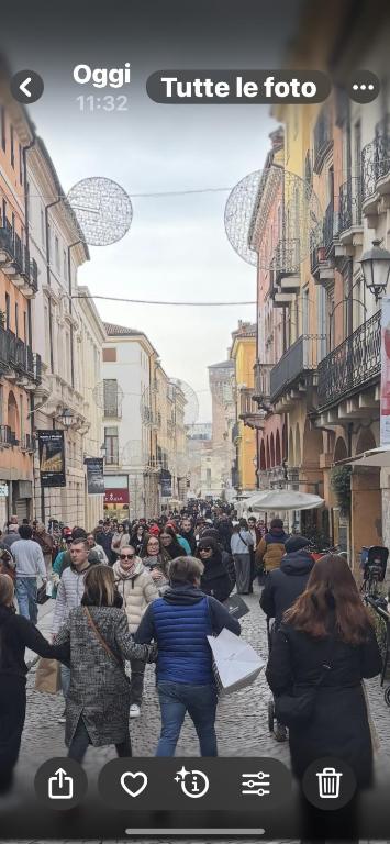 a group of people walking down a city street at la promenade in Vicenza