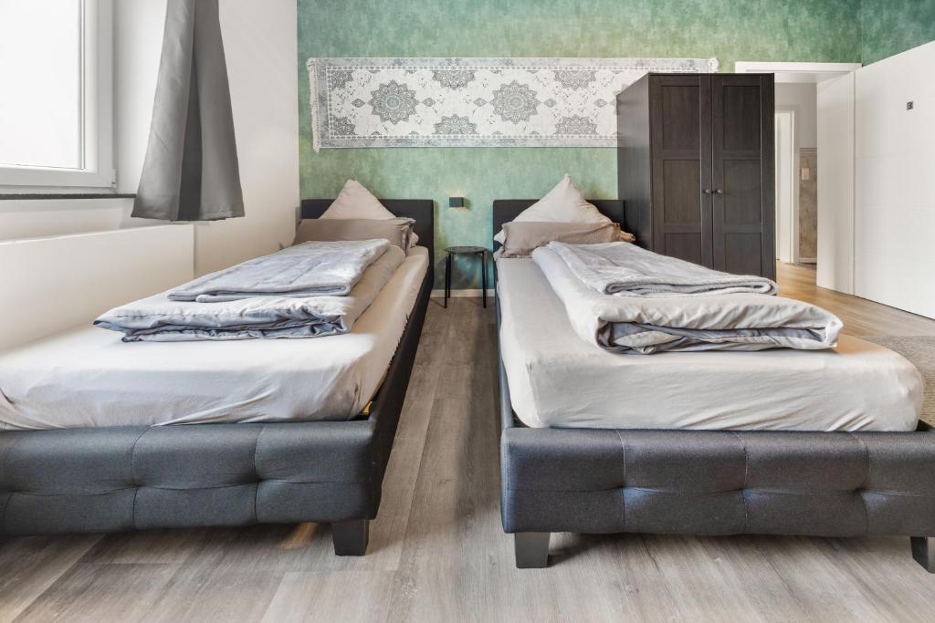 two beds sitting next to each other in a room at Heide Ferienwohnung Süd Nr-2 in Schneverdingen