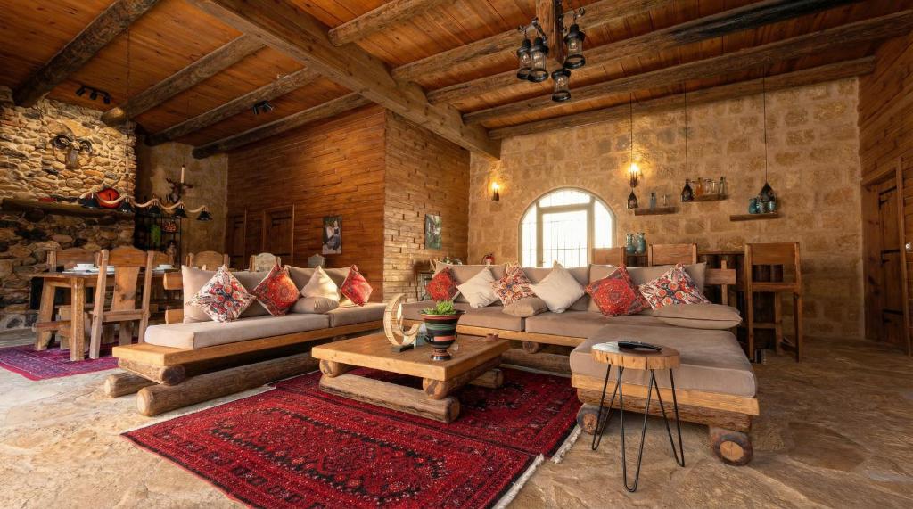 a large living room with couches and a table at Golden Heights Resort in Al Ḩanī